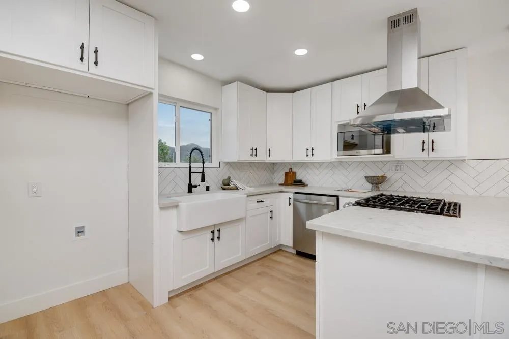 9428 Leticia Drive Santee, CA 92071 - Photo 7 of 17 a kitchen with a sink a stove and cabinets