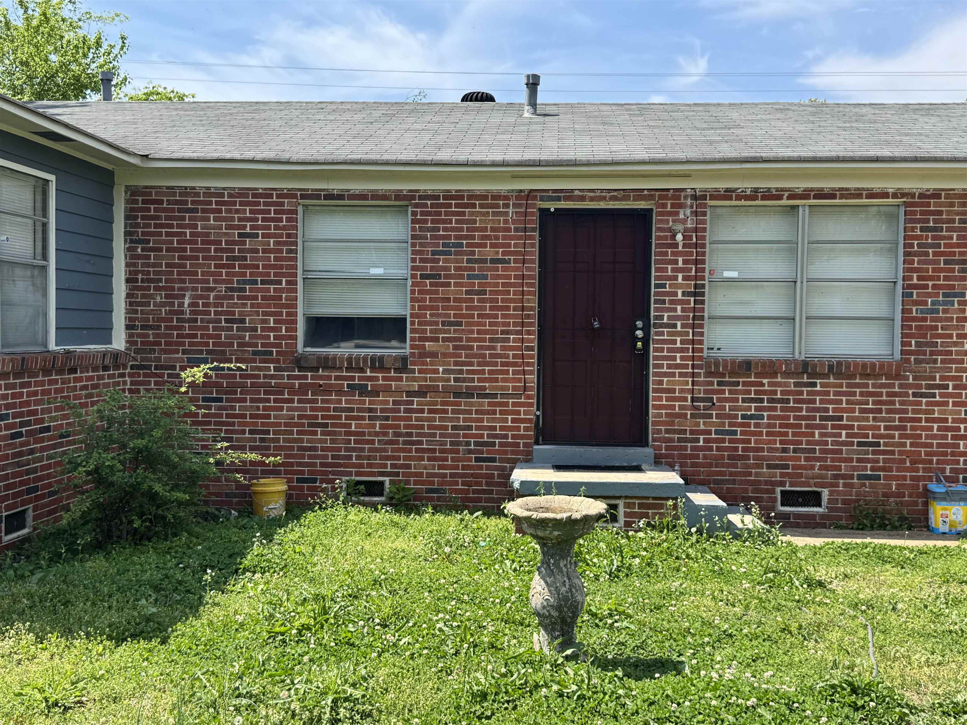 5133 Stacey Road Memphis, TN 38109 - Photo 3 of 10 Entrance to property featuring crawl space, brick siding, and a lawn