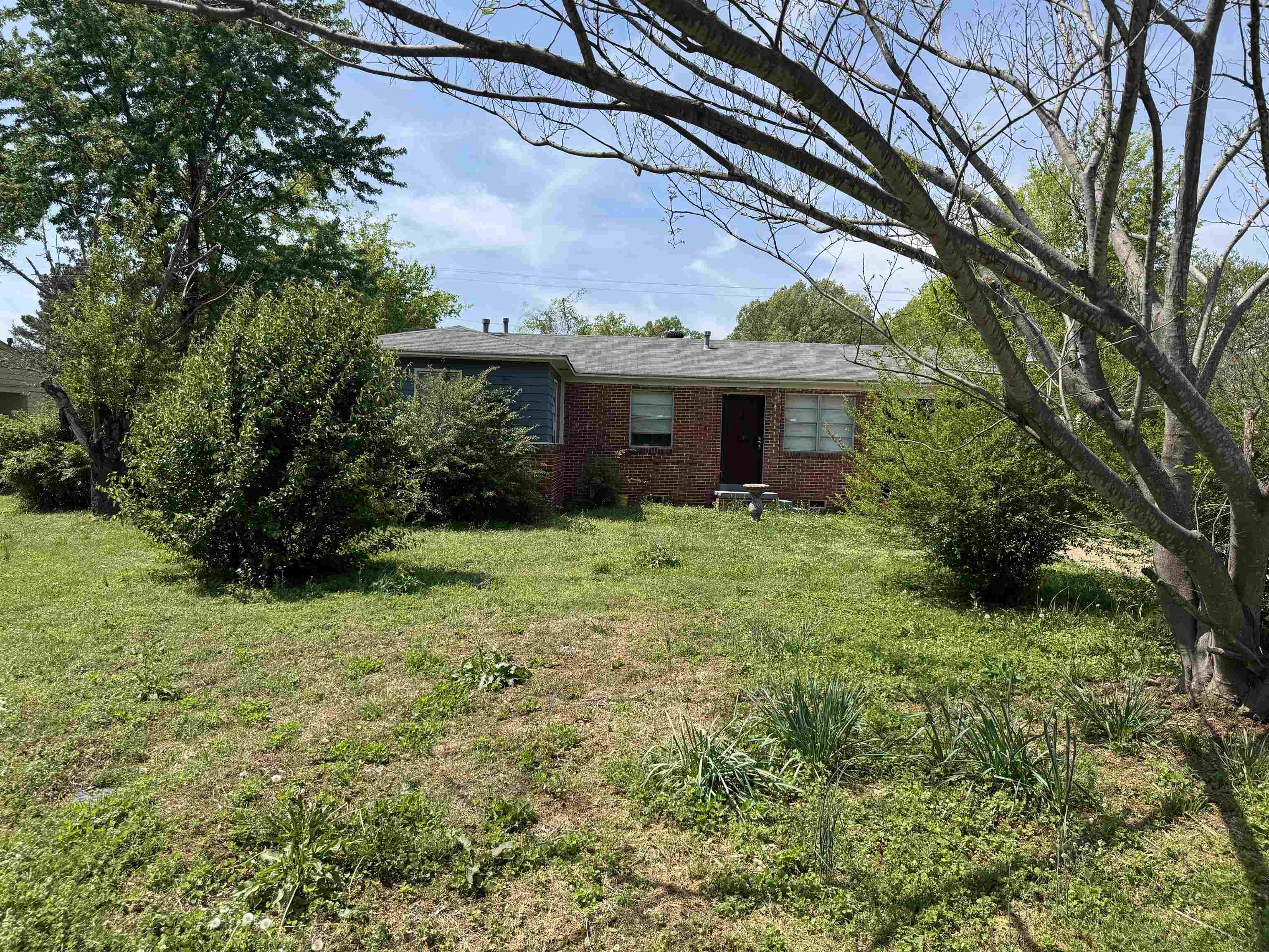 5133 Stacey Road Memphis, TN 38109 - Photo 8 of 10 View of front of property with brick siding and a front yard