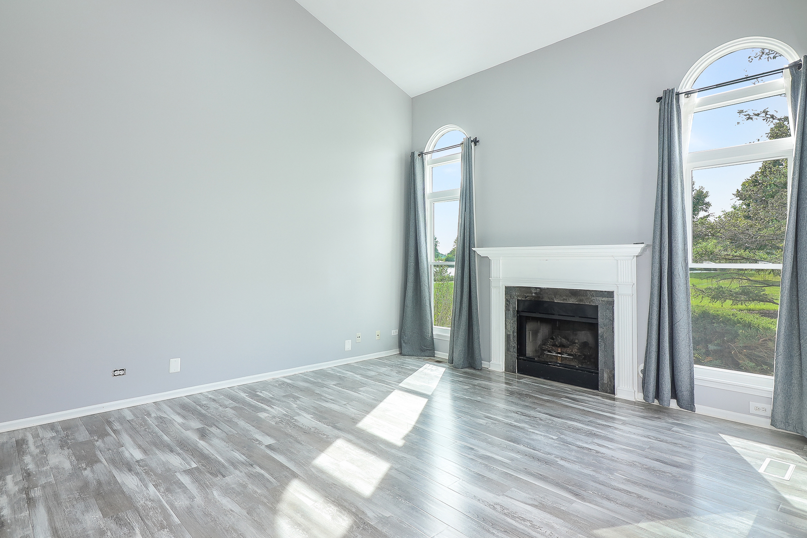1288 Lakeshore Drive Carol Stream, IL 60188 - Photo 4 of 25 a view of empty room with wooden floor and fireplace