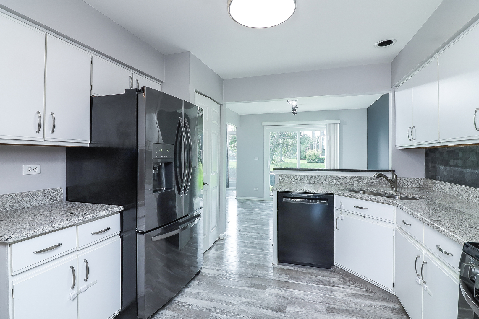 1288 Lakeshore Drive Carol Stream, IL 60188 - Photo 8 of 25 a kitchen with a sink stove and refrigerator