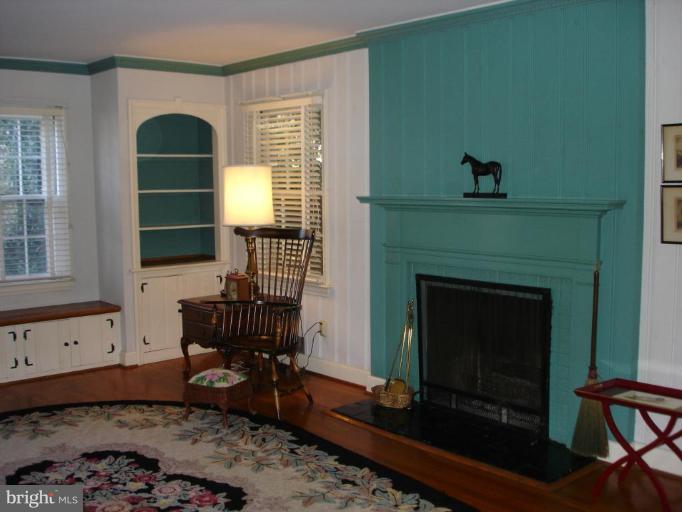 1205 Lake Falls Road Baltimore, MD 21210 - Photo 2 of 20 Living room w/hdwd, FP, dentil molding & built-in.