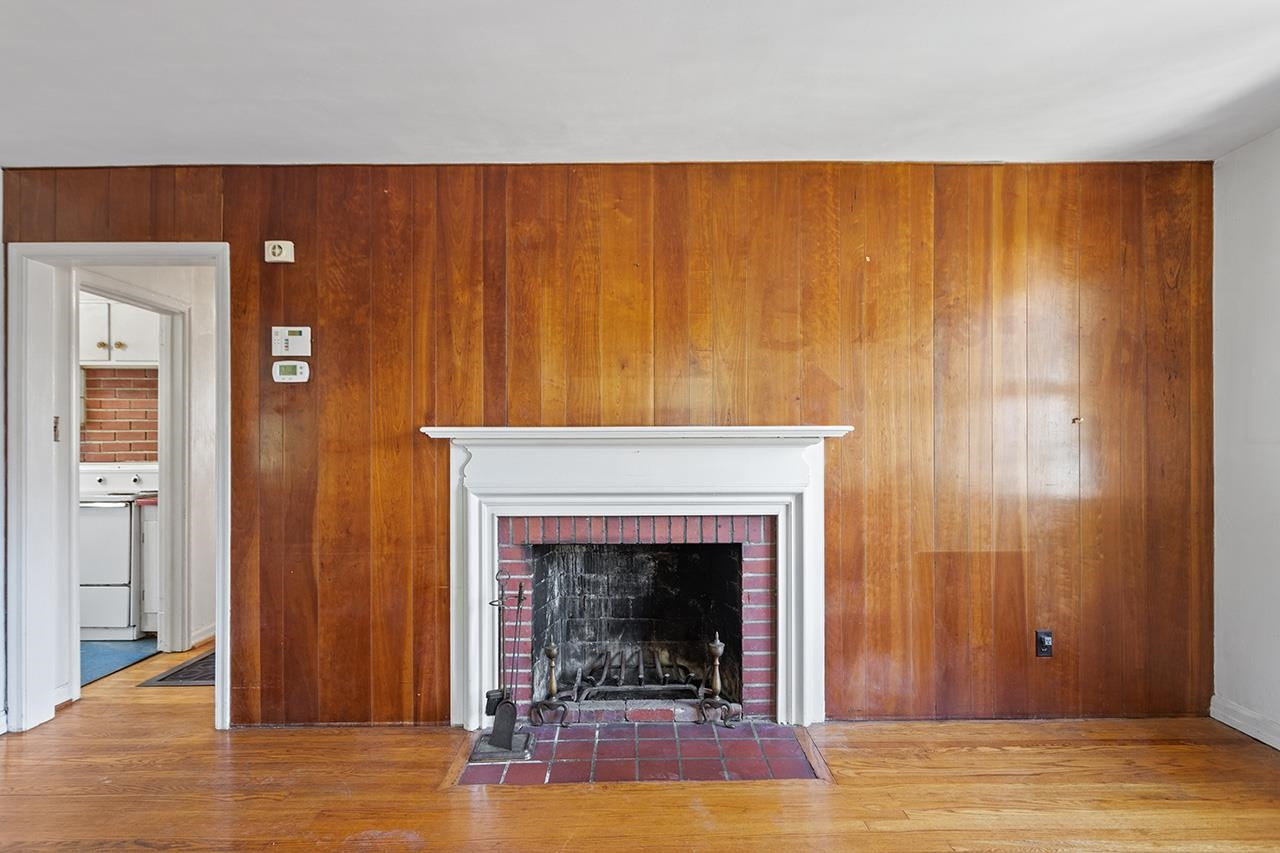 1208 Clifton Street Raleigh, NC 27604 - Photo 3 of 33 A decent amount of original charm remains, such as the masonry fireplace (decorative only and needs repair) and wood paneling in the living room