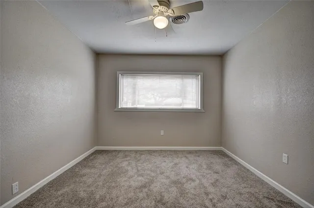 a view of a big room with yard and large tree