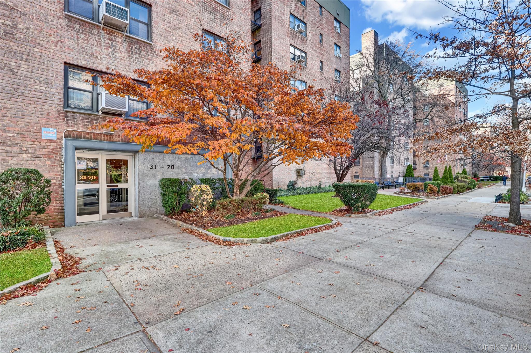 31-70 138th Street, Unit 3H Queens, NY 11354 - Photo 1 of 18 front view of a building with a yard