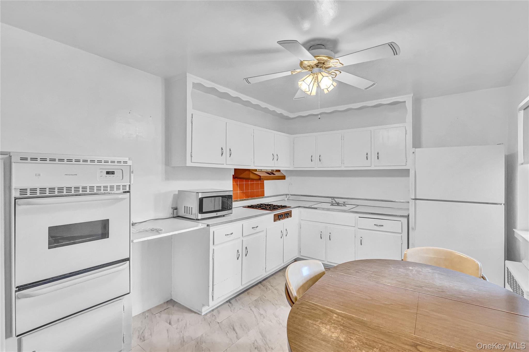 31-70 138th Street, Unit 3H Queens, NY 11354 - Photo 11 of 18 a kitchen with a stove a sink and dishwasher