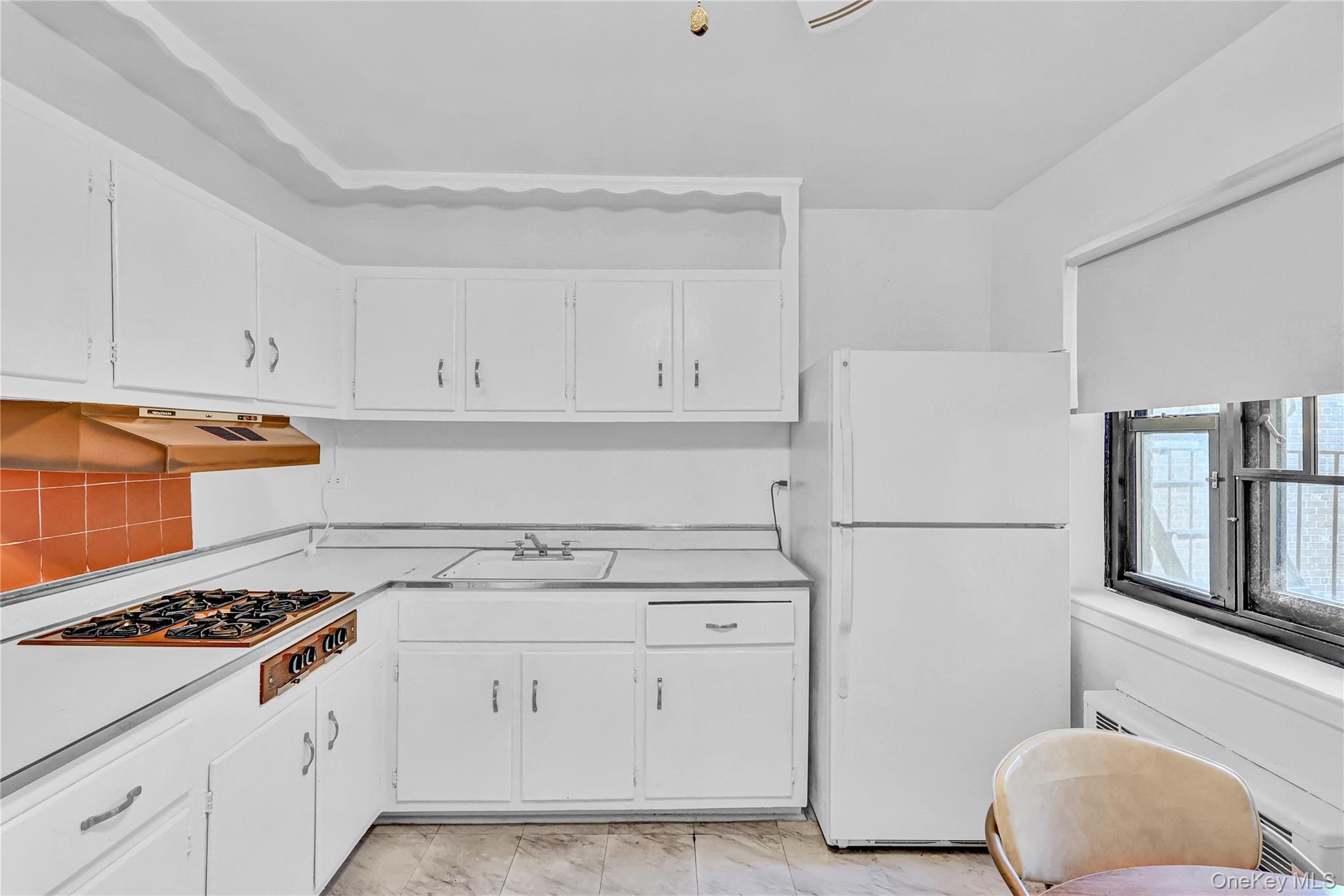 31-70 138th Street, Unit 3H Queens, NY 11354 - Photo 12 of 18 a kitchen with white cabinets and white appliances