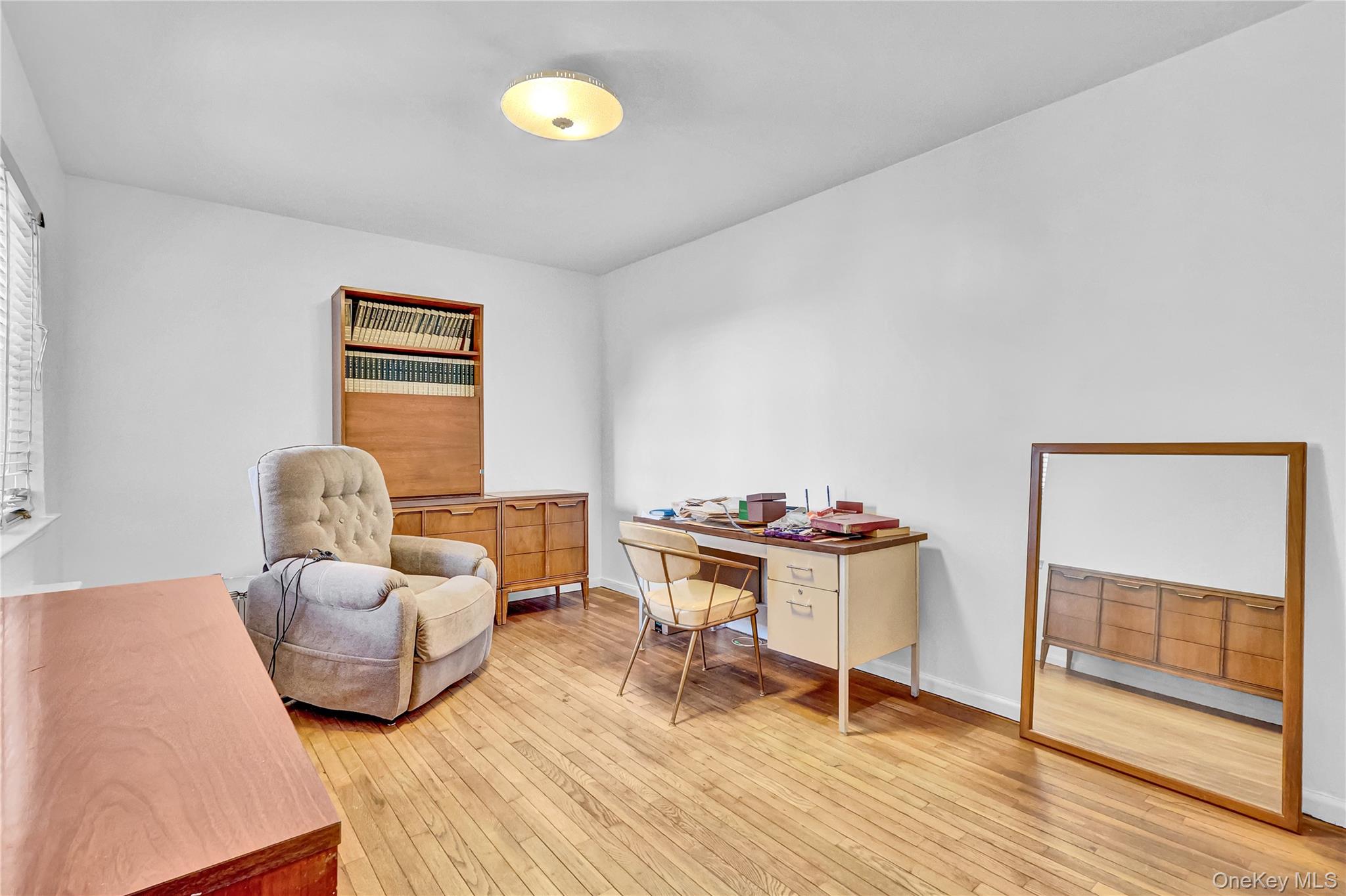 31-70 138th Street, Unit 3H Queens, NY 11354 - Photo 14 of 18 a living room with furniture and a wooden floor