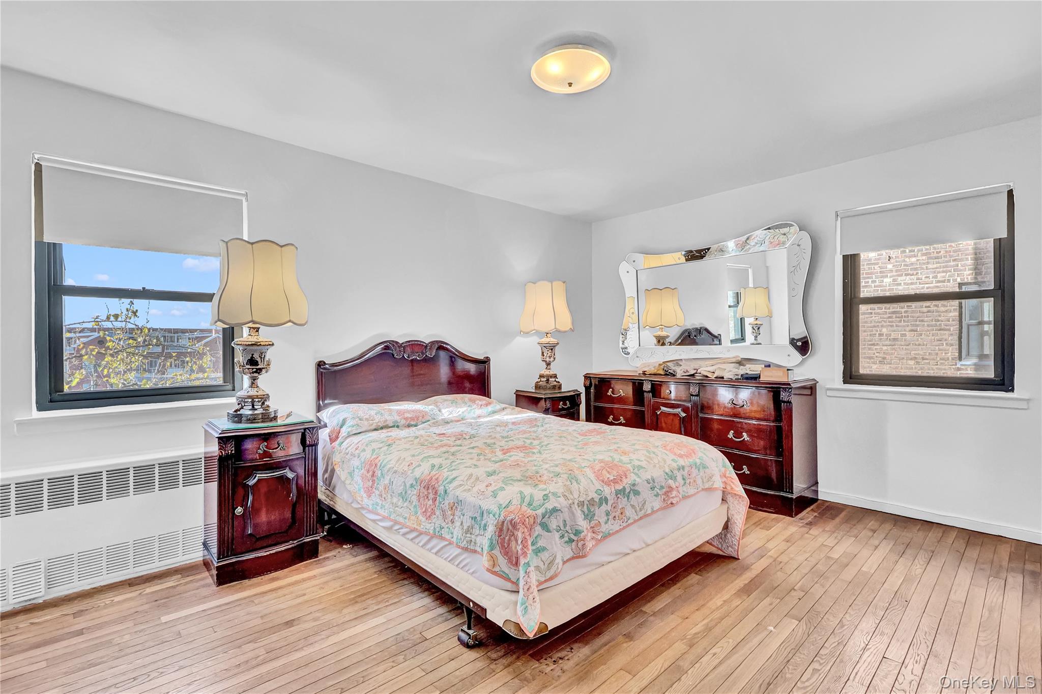 31-70 138th Street, Unit 3H Queens, NY 11354 - Photo 16 of 18 a bedroom with a bed and wooden floor