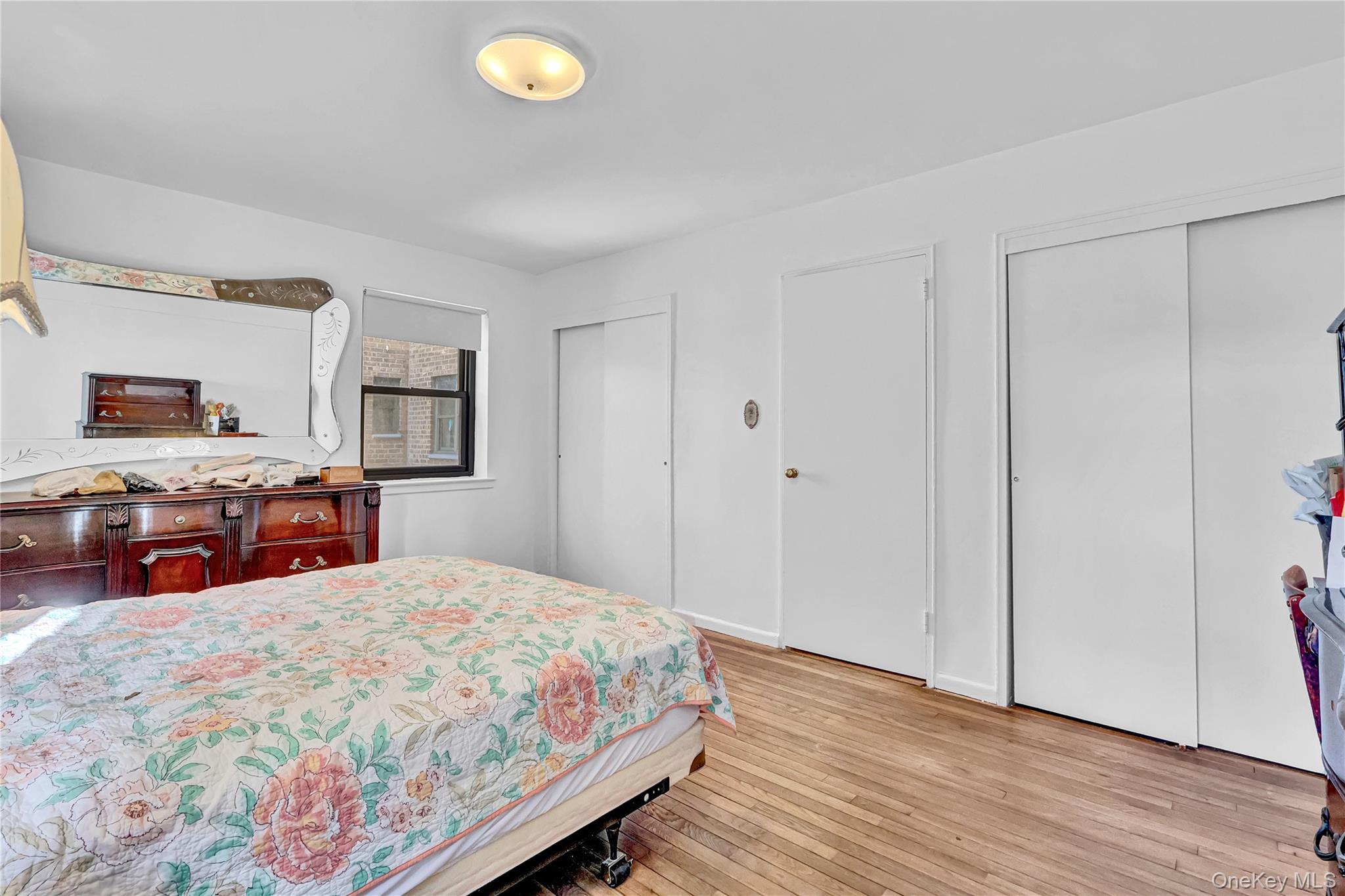 31-70 138th Street, Unit 3H Queens, NY 11354 - Photo 17 of 18 a bed room with a bed and a tv