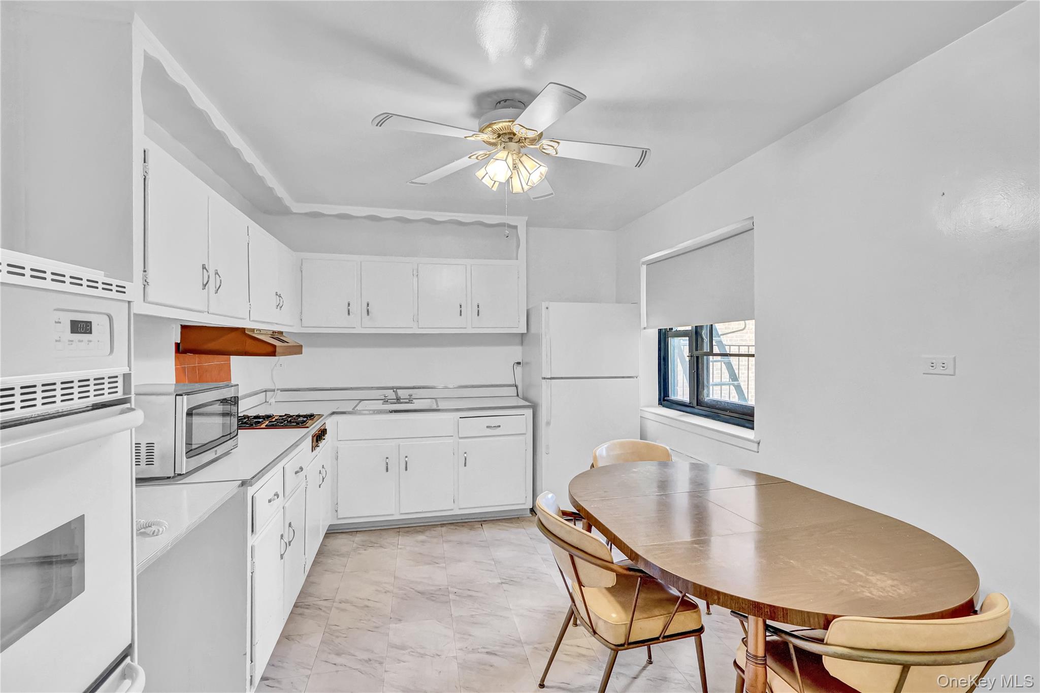 31-70 138th Street, Unit 3H Queens, NY 11354 - Photo 10 of 18 a kitchen with stainless steel appliances granite countertop a stove a sink dishwasher and a refrigerator with wooden floor