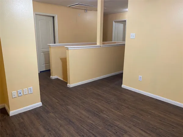 an empty room with wooden floor