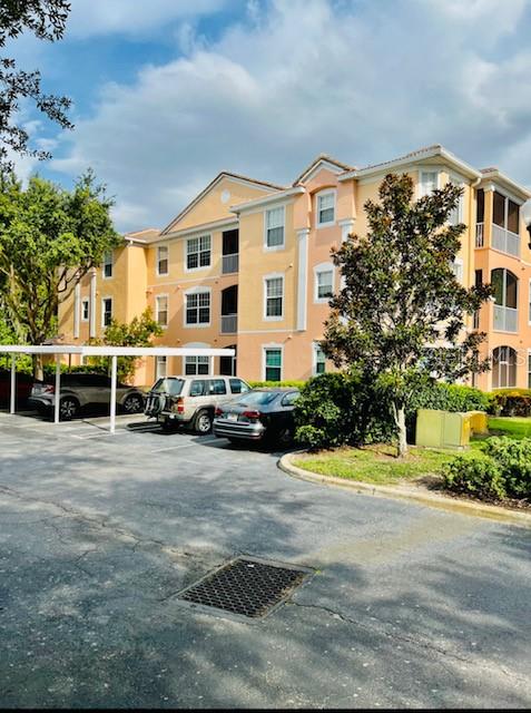 13548 Turtle Marsh Loop, Unit 431 Orlando, FL 32837 - Photo 1 of 1 a front view of a building with cars parked