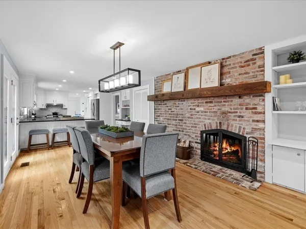 a dining room with furniture and wooden floor