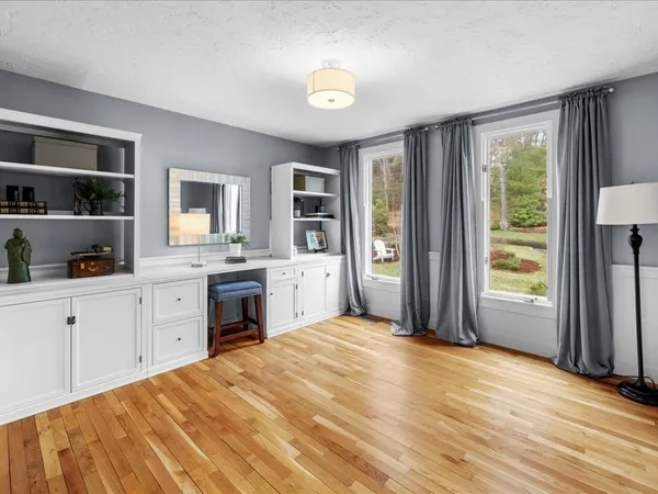 a view of a livingroom with wooden floor and a flat screen tv
