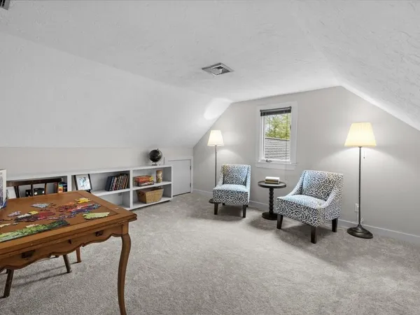 a view of a livingroom with furniture and a table