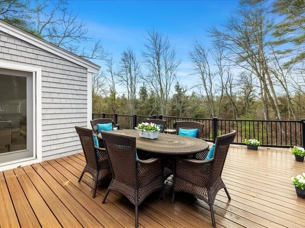 a outdoor view with a sitting space and large trees
