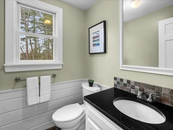 a view of a room with wooden floor and a window