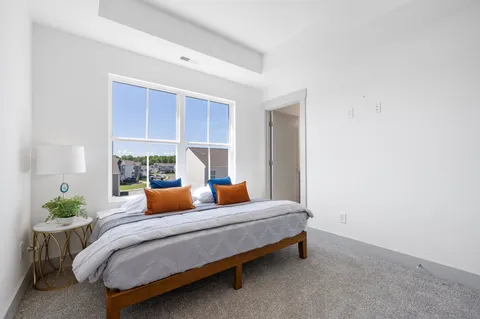 a bedroom with furniture and a potted plant
