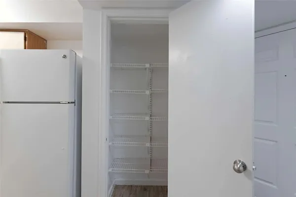 a white refrigerator freezer and a dishwasher with wooden floor