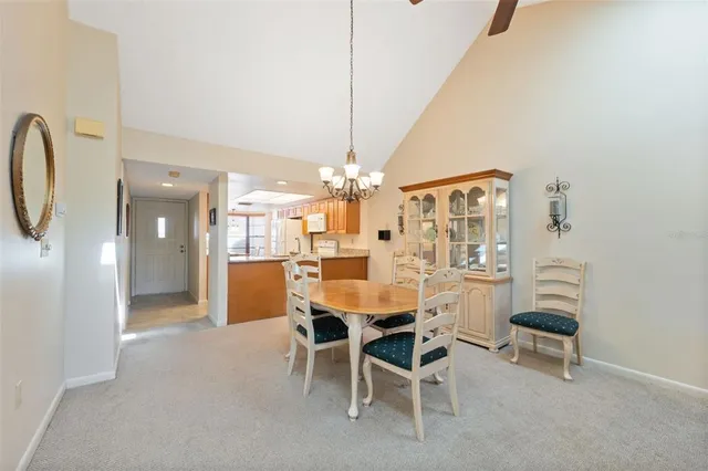 a view of a dining room with furniture and chandelier