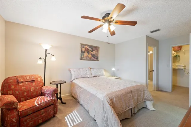 a bedroom with a bed couch and window