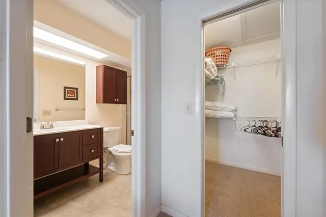 a spacious bathroom with a toilet sink and mirror