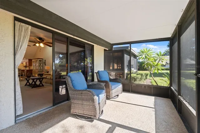 a living room with furniture and a floor to ceiling window