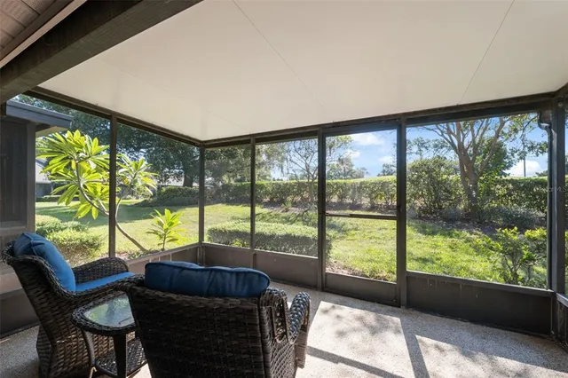 a living room with furniture and a floor to ceiling window