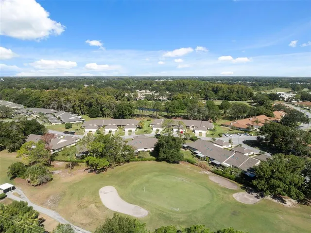 an aerial view of residential houses with outdoor space and swimming pool