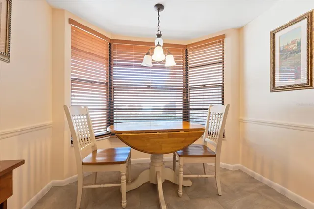 a dining room with furniture and window