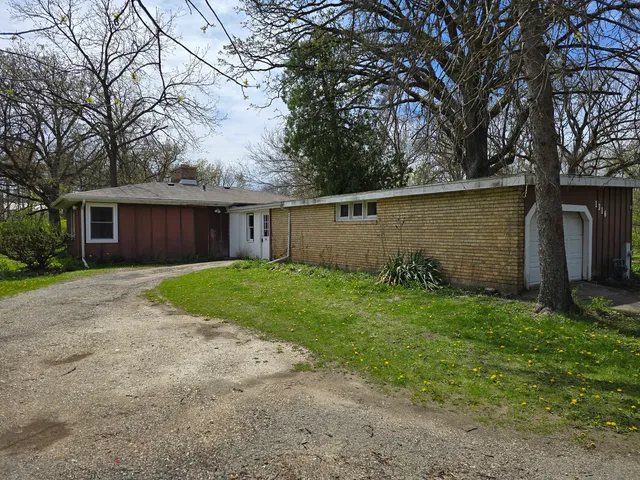 a view of a house with yard and a garden