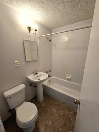 a white toilet sitting next to a bathroom sink