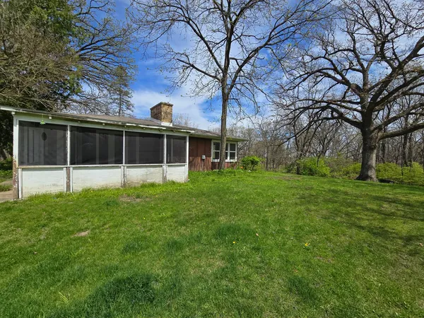 a view of an house with backyard space and garden