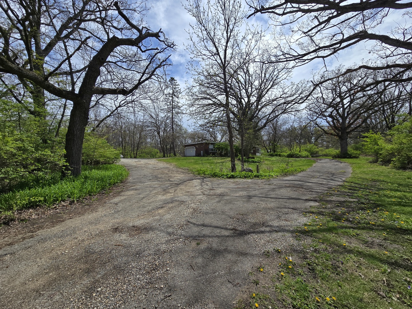 1316 South Fleming Road, Unit A Woodstock, IL 60098 - Photo 2 of 18 a view of a yard with plants and trees