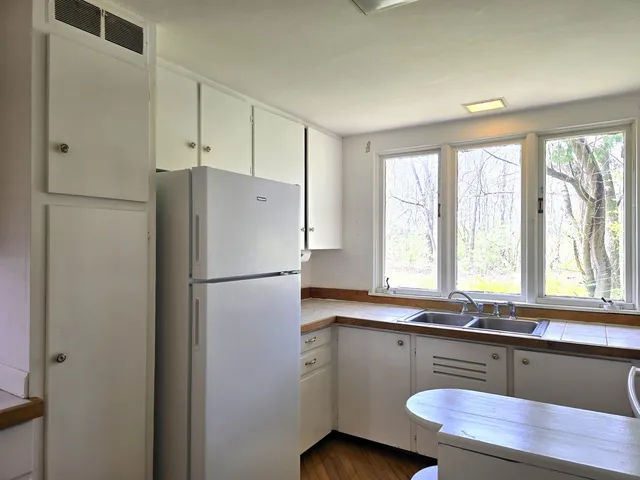 a white refrigerator freezer sitting inside of a kitchen