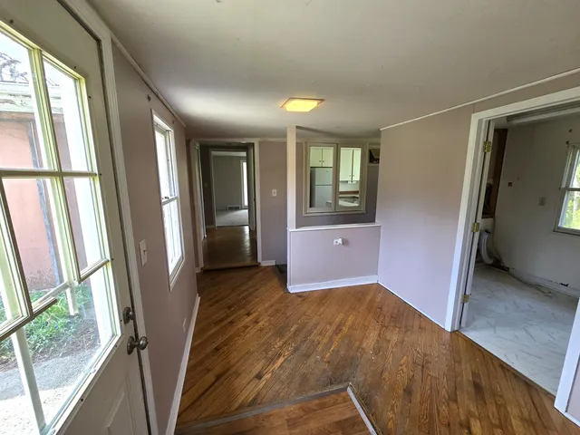 a view of entryway with window and wooden floor