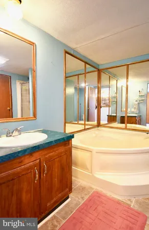 a spacious bathroom with a vanity and a large mirror