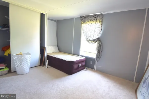 a spacious bedroom with a bed and window