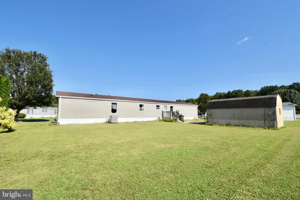 a view of a big yard with an outdoor seating