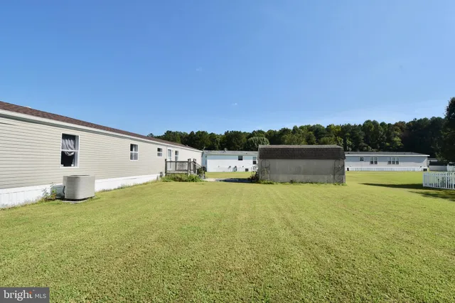 a house view with swimming pool in front of it
