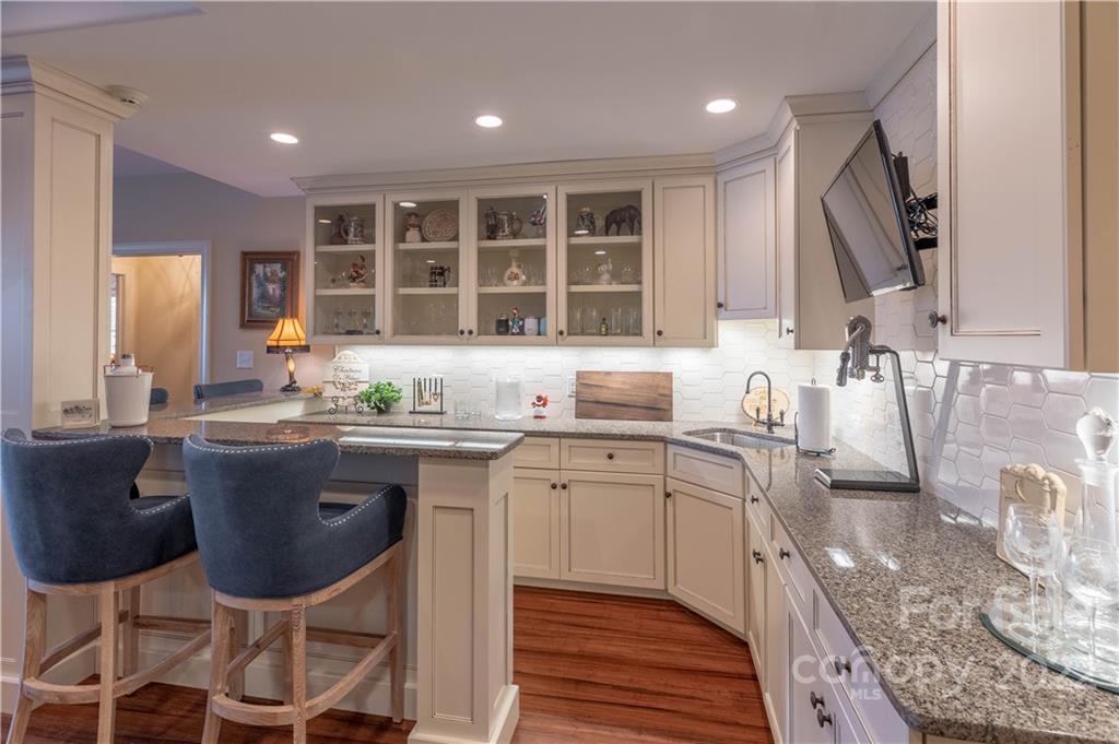 1849 Southpointe Drive Morganton, NC 28655 - Photo 29 of 48 a kitchen with a sink dining table and chairs