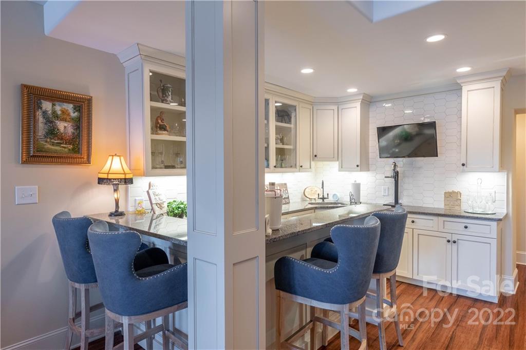 1849 Southpointe Drive Morganton, NC 28655 - Photo 30 of 48 a kitchen with kitchen island granite countertop wooden cabinets and dining table