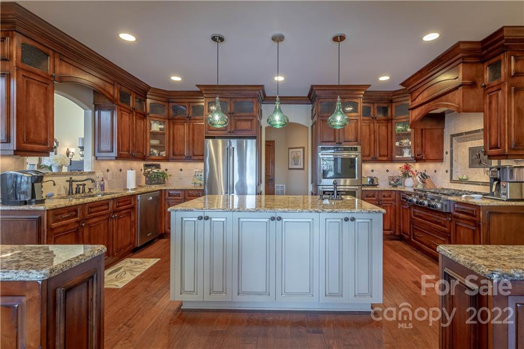 1849 Southpointe Drive Morganton, NC 28655 - Photo 7 of 48 a kitchen with stainless steel appliances granite countertop wooden cabinets a stove top oven a sink and dishwasher