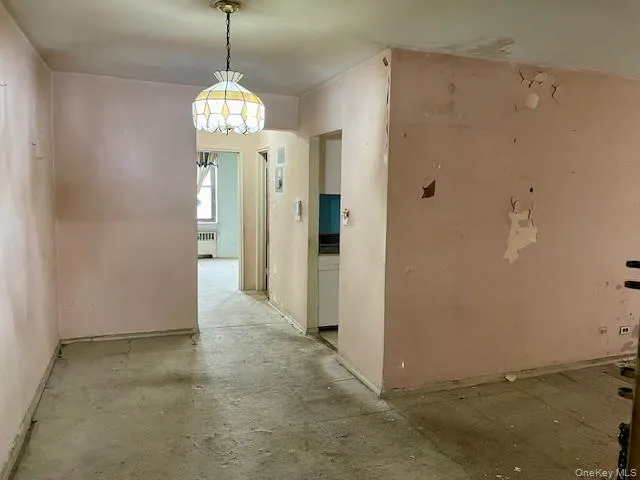 a view of a hallway with chandelier front door