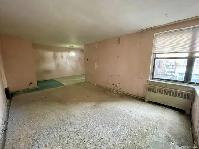 an empty room with a empty space and windows