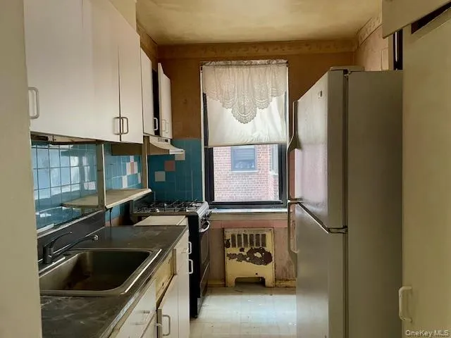 a kitchen with a refrigerator and a sink