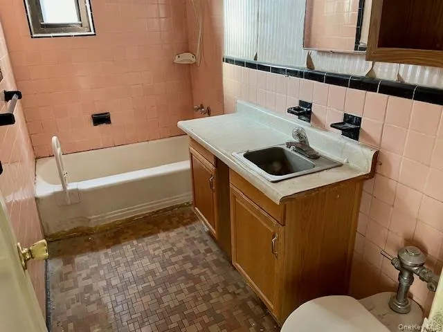 a bathroom with a sink toilet and tub