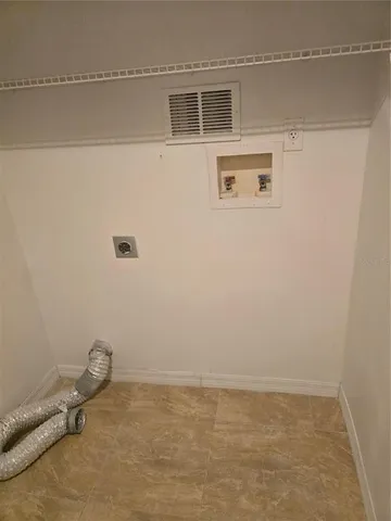 a view of a room with an empty space and a window