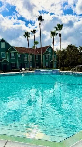 a view of a park with a house in the background